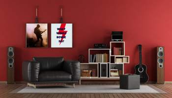 An apartment with speakers, instruments, and music posters